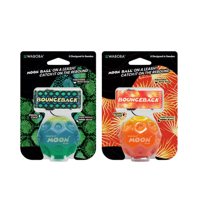 Two packaged Waboba Moon Ball leash catchers on a white background, one in green with a snake-print backing card and one in orange with a floral-print backing card.