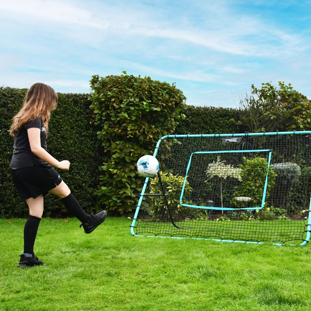 PrecisionPLAY Mega Rebounder in use in garden with girl playing football